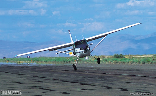 A small single-engine airplane landing in crosswind